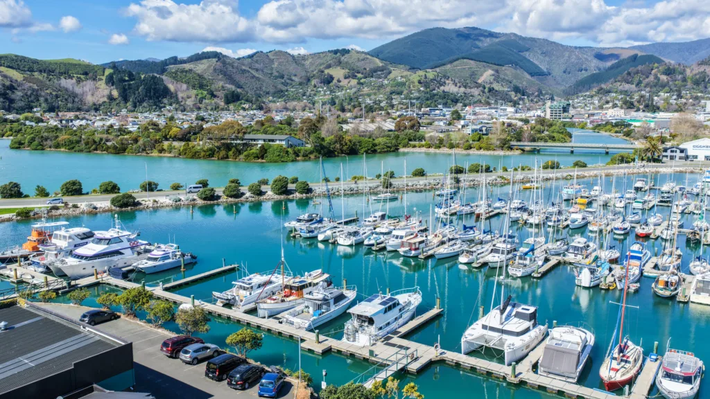 Nelson Marina with yachts and launches, the Maitai River and the hills behind Nelson city