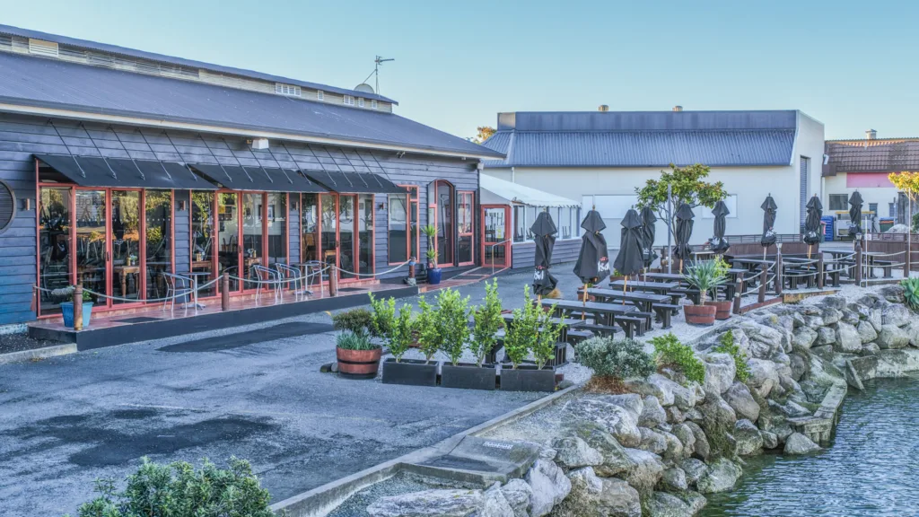 Anchor Restaurant waterfront dining with outdoor tables next to Harbourside Nelson