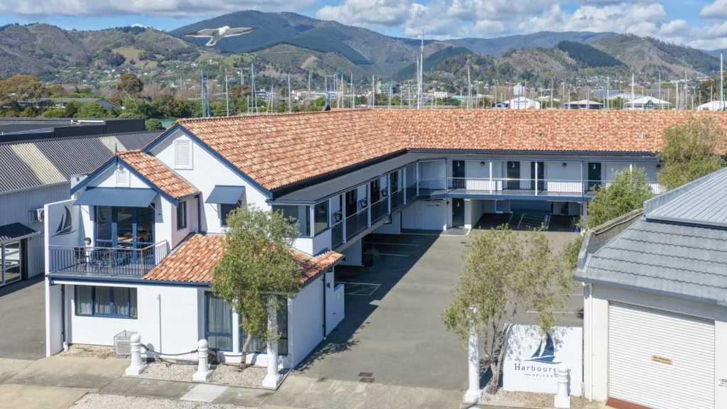 Aerial view of Harbourside Nelson entrance and courtyard with the marina and hills behind