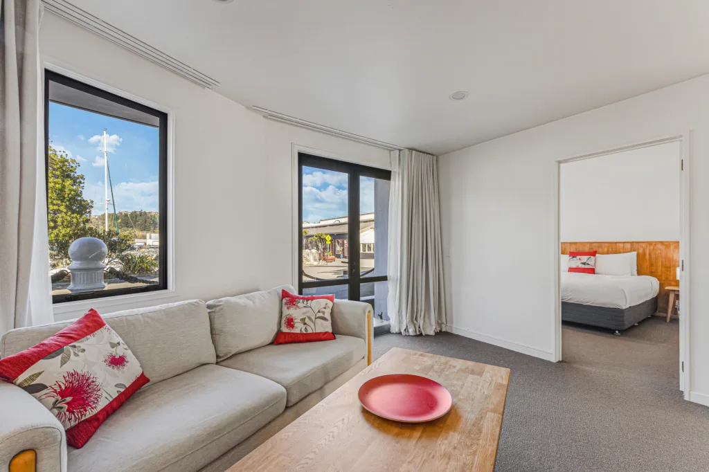 Marina Front Apartment lounge with sofa and marina glimpses, and the bedroom beyond