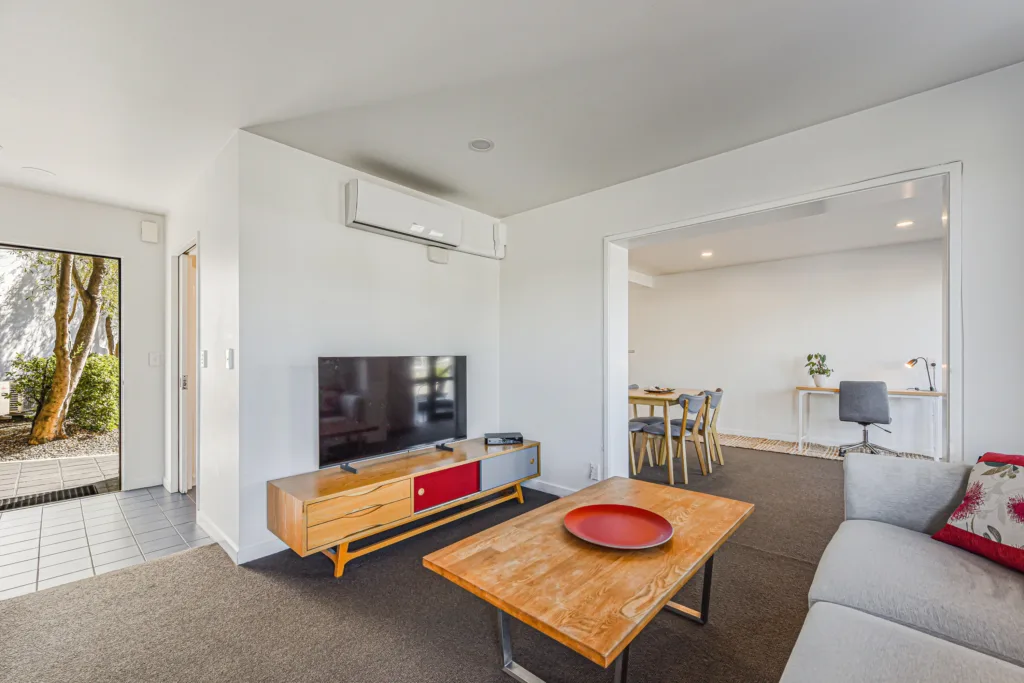 Marina Front Apartment living area with TV, sofa and dining and work area beyond