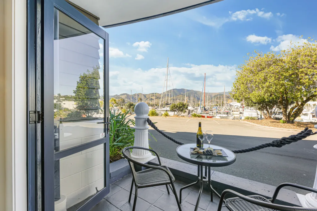 Private patio with wine and a platter looking across to Nelson Marina and the hills