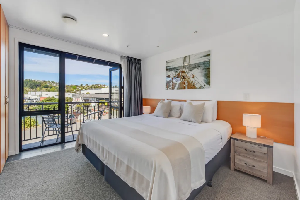 Marina View Apartment bedroom with super king bed and doors to a balcony