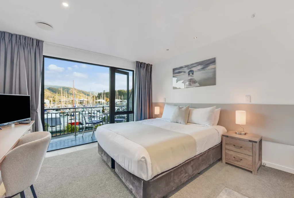 Marina View Studio with super king bed and floor-to-ceiling doors looking out to a marina view balcony
